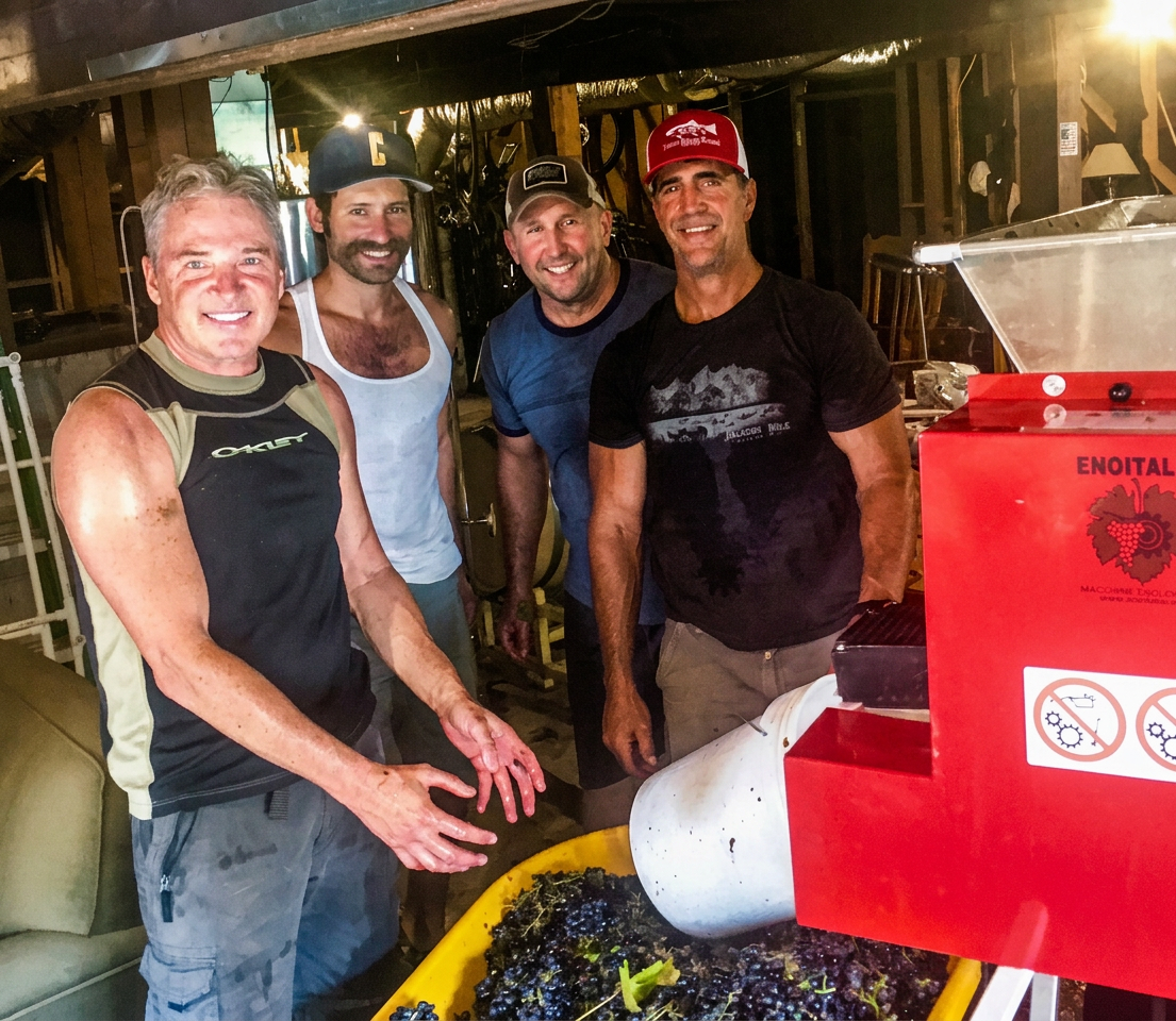 Ray with friends crushing grapes in the basement
