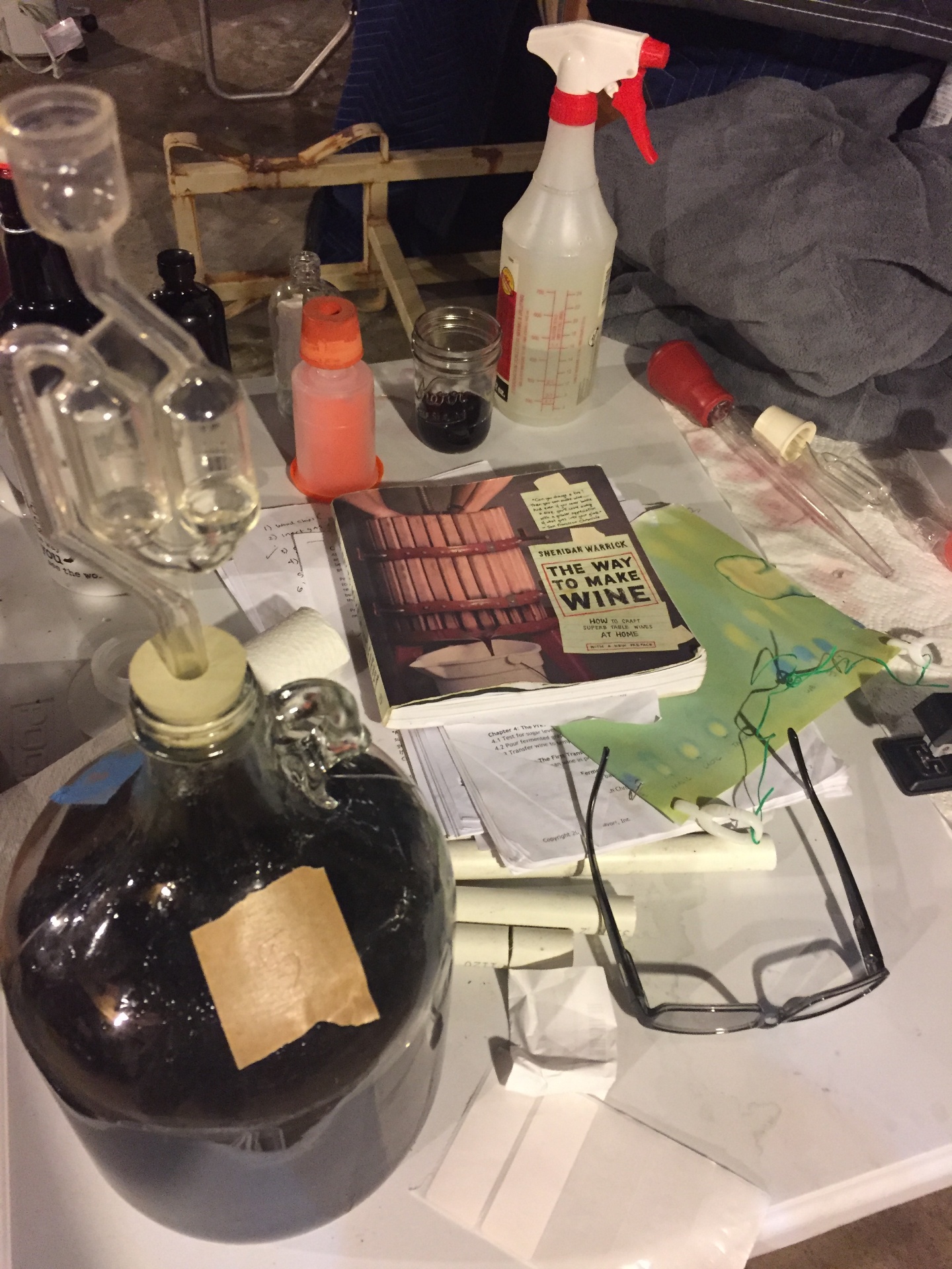 Carboy fermenting wine with airlock and notes