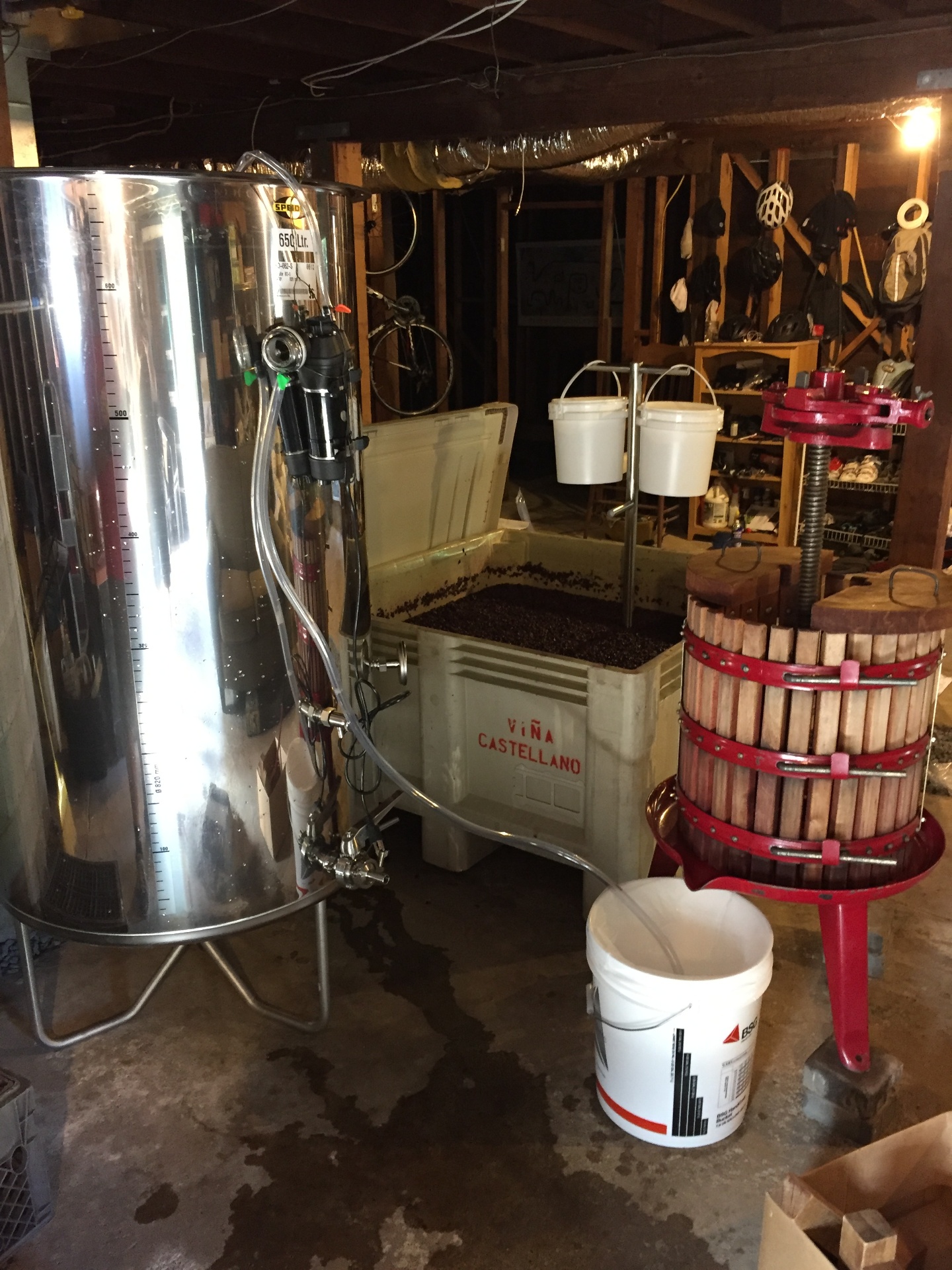 The original tiny tank, press, and fermentation bin in the basement